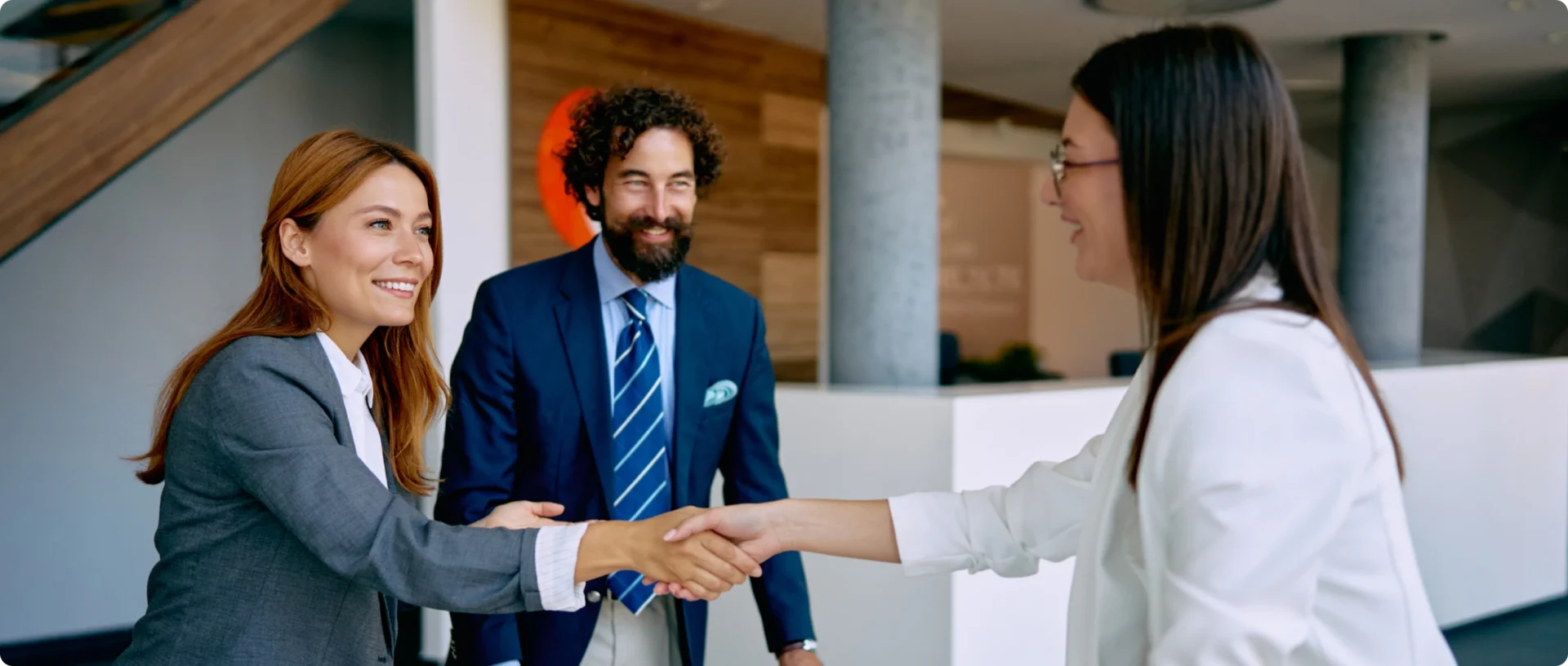 Friendly handshake between office coworkers